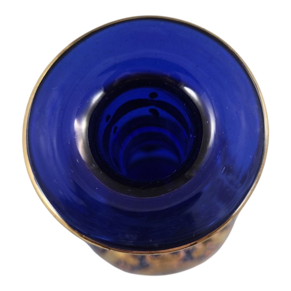 A cobalt blue Bohemian glass decanter decorated with elaborate gold enamelling and a painted portrait medallion, featuring a tall pointed stopper. View VI