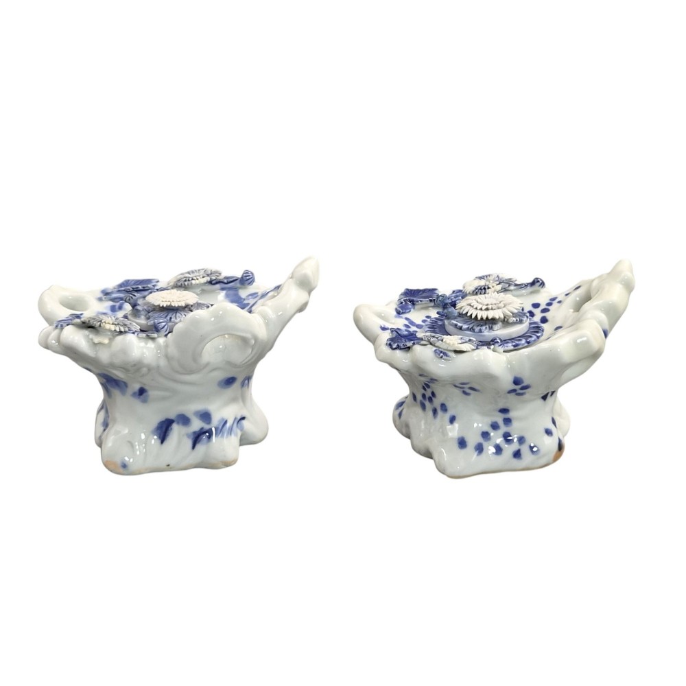 A pair of Japanese Hirado porcelain inkwells featuring fluted bases, underglaze blue decoration, and three-dimensional chrysanthemum motifs on the lids. View V