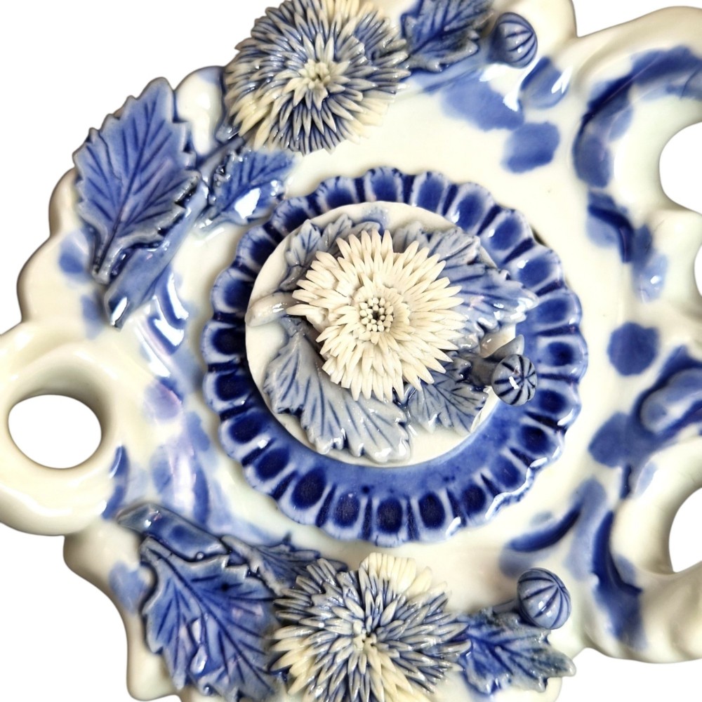 A pair of Japanese Hirado porcelain inkwells featuring fluted bases, underglaze blue decoration, and three-dimensional chrysanthemum motifs on the lids. View XII