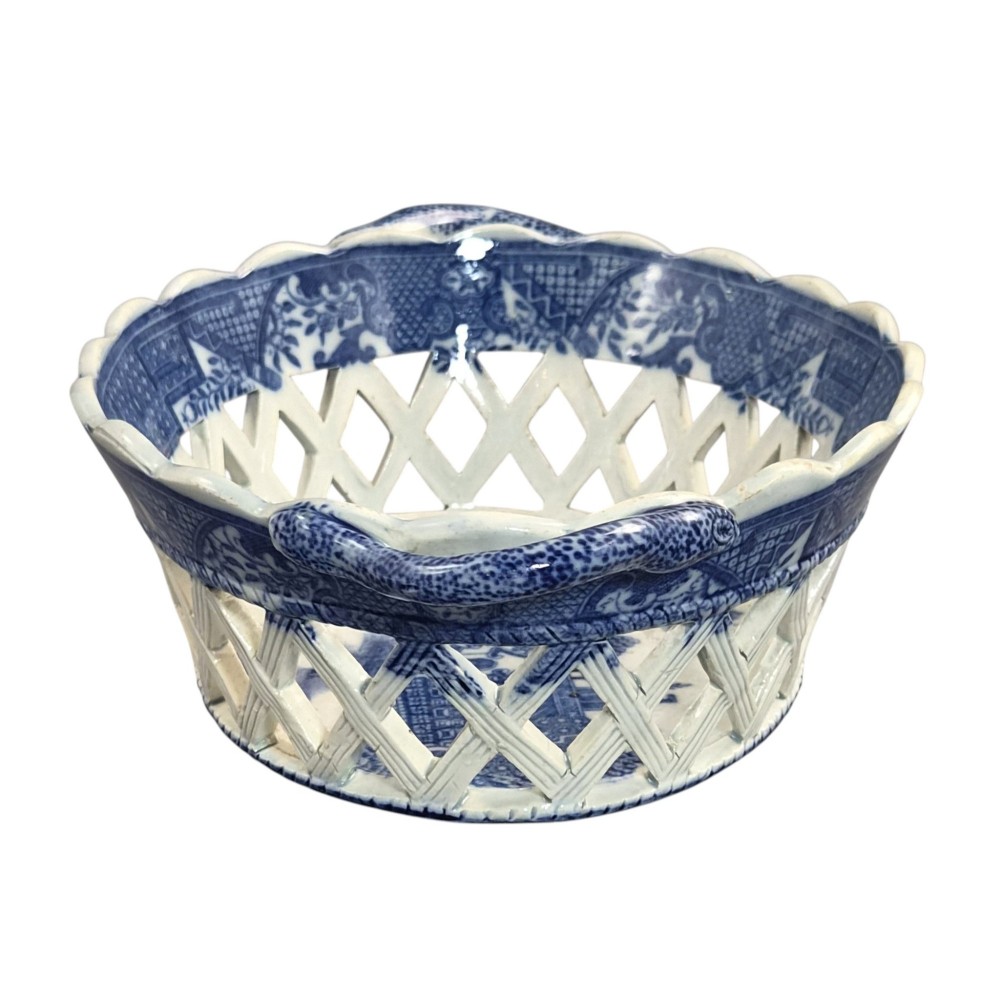 A Regency period blue and white transfer-printed ceramic chestnut basket featuring openwork reticulated lattice sides and two loop side handles. View III
