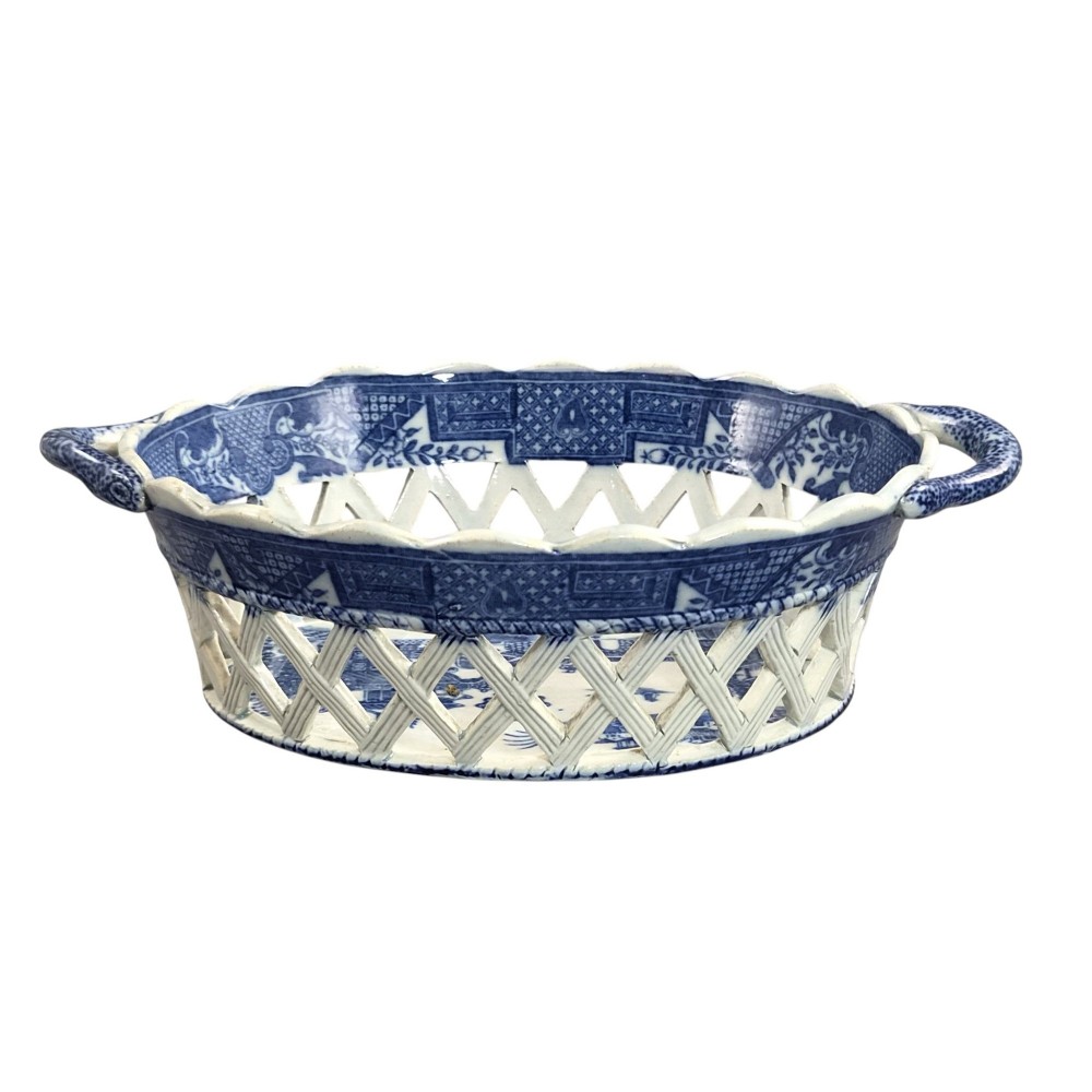 A Regency period blue and white transfer-printed ceramic chestnut basket featuring openwork reticulated lattice sides and two loop side handles. View IV