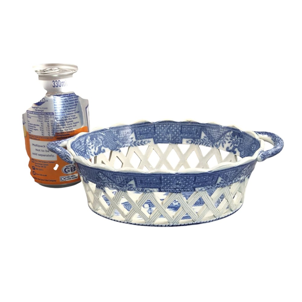 A Regency period blue and white transfer-printed ceramic chestnut basket featuring openwork reticulated lattice sides and two loop side handles. View IX