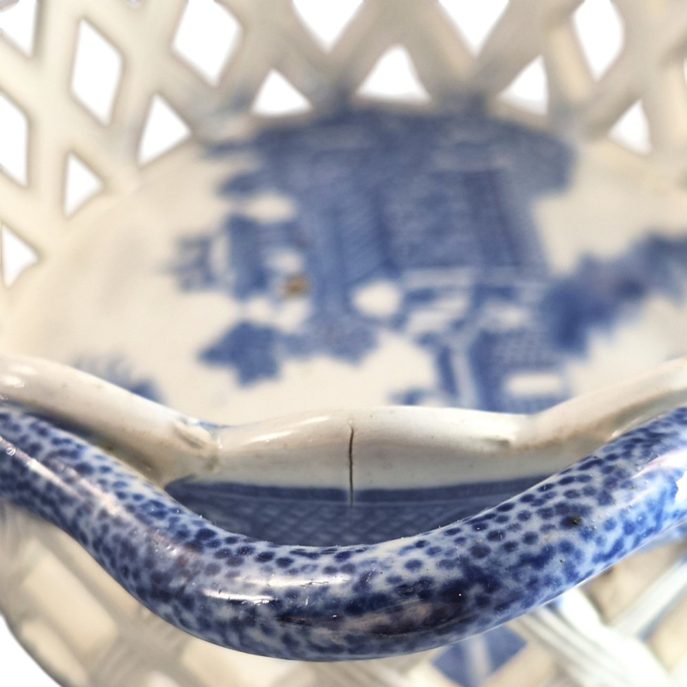 A Regency period blue and white transfer-printed ceramic chestnut basket featuring openwork reticulated lattice sides and two loop side handles. View XI