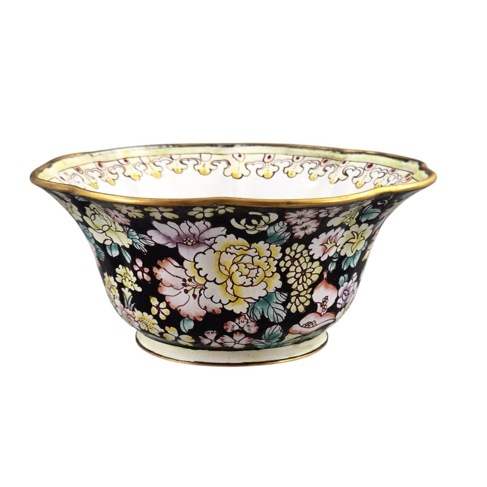 A Chinese Canton enamel-on-copper bowl featuring a lobed rim, a black ground exterior decorated with colourful floral motifs, and a white interior with a patterned border. View III