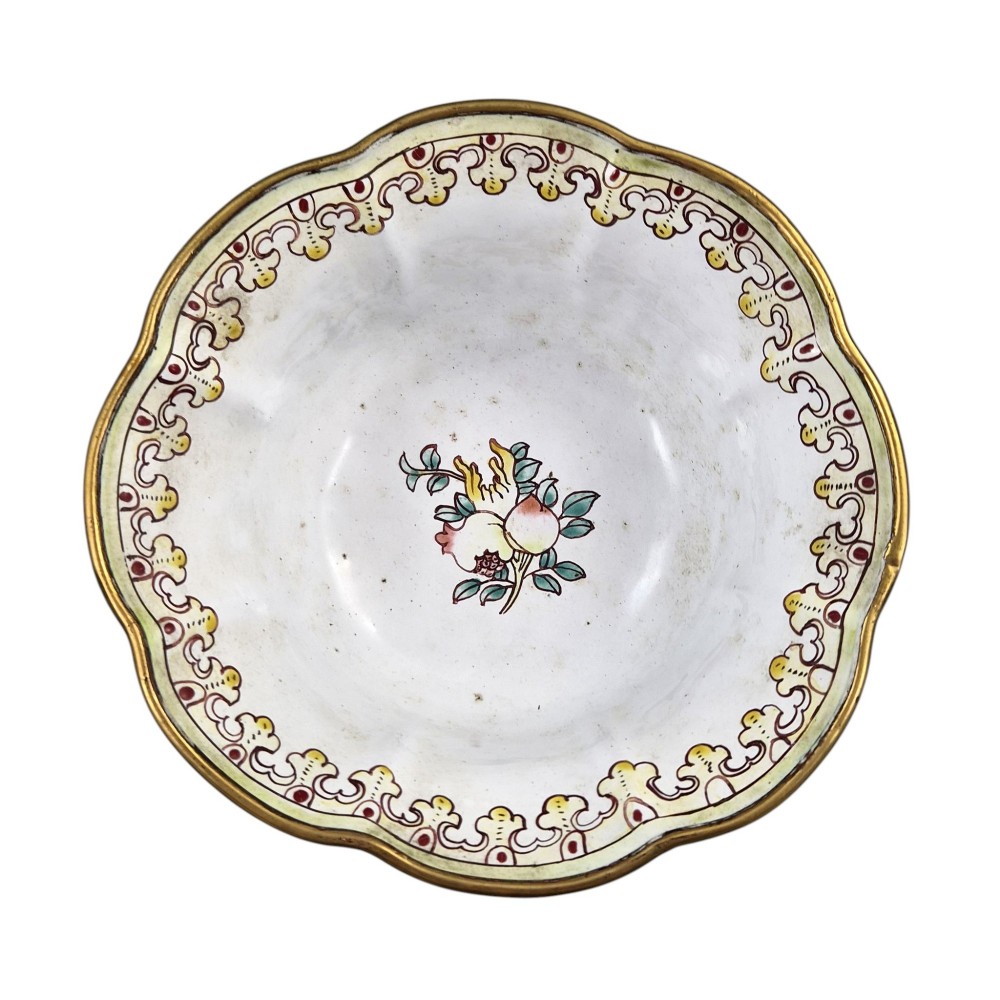A Chinese Canton enamel-on-copper bowl featuring a lobed rim, a black ground exterior decorated with colourful floral motifs, and a white interior with a patterned border. View VI