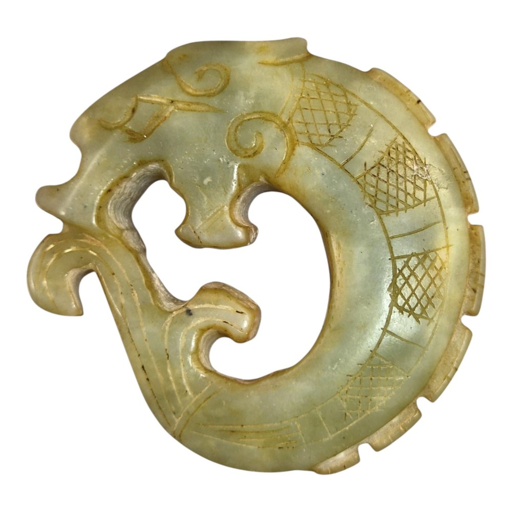 A group of three carved Chinese stone amulets featuring a carp, a central circular bi disc with a qilin, and a chilong dragon. View III