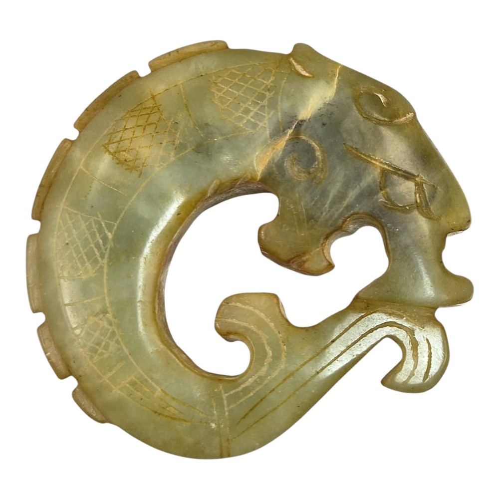 A group of three carved Chinese stone amulets featuring a carp, a central circular bi disc with a qilin, and a chilong dragon. View IV