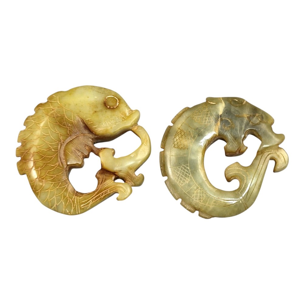 A group of three carved Chinese stone amulets featuring a carp, a central circular bi disc with a qilin, and a chilong dragon. View V