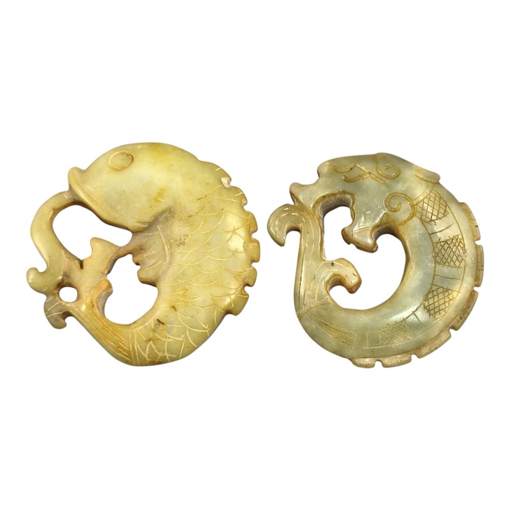 A group of three carved Chinese stone amulets featuring a carp, a central circular bi disc with a qilin, and a chilong dragon. View VI