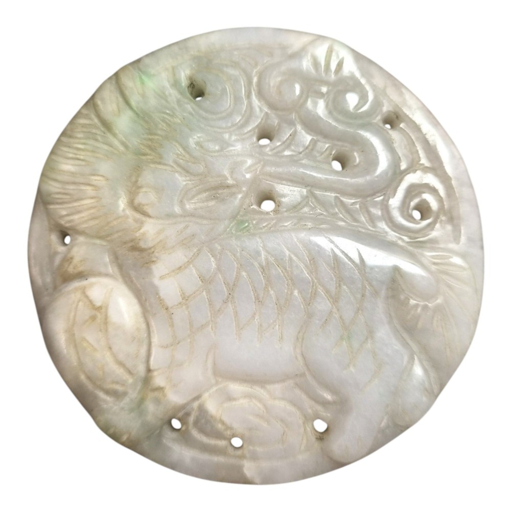 A group of three carved Chinese stone amulets featuring a carp, a central circular bi disc with a qilin, and a chilong dragon. View VII