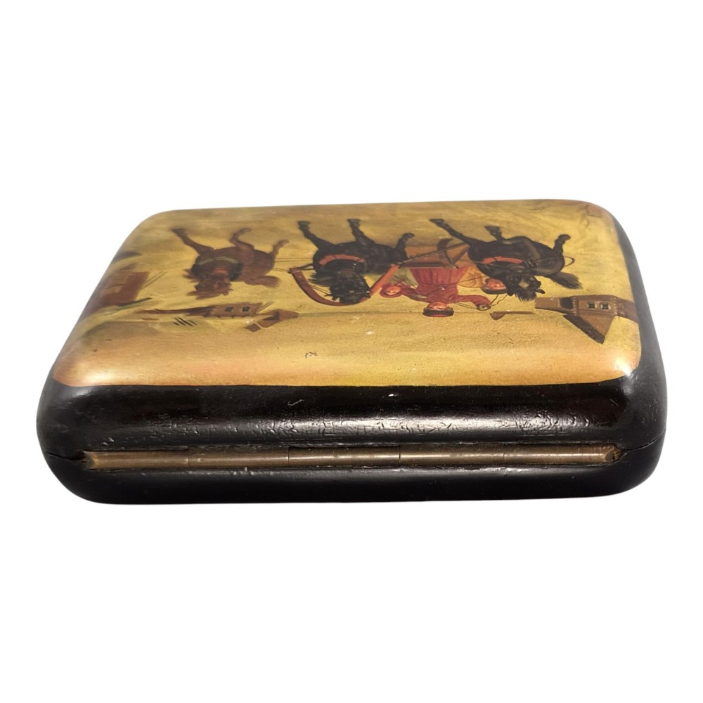 A rectangular 19th-century Russian lacquer cigarette case featuring a hand-painted scene of three horses pulling a sleigh across a snowy landscape on a gold background. View II