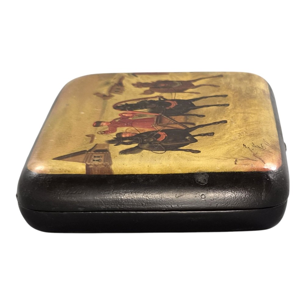 A rectangular 19th-century Russian lacquer cigarette case featuring a hand-painted scene of three horses pulling a sleigh across a snowy landscape on a gold background. View III