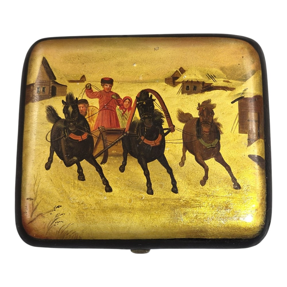 A rectangular 19th-century Russian lacquer cigarette case featuring a hand-painted scene of three horses pulling a sleigh across a snowy landscape on a gold background. View XI