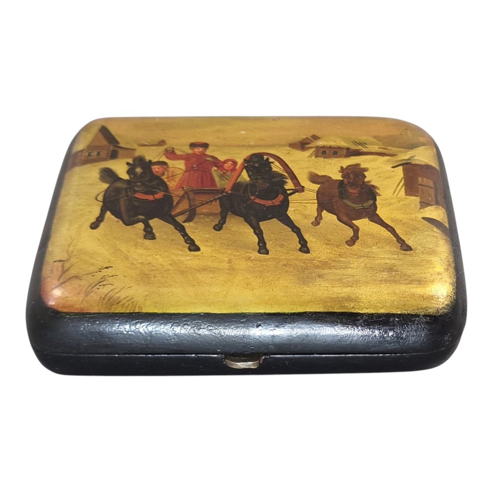 A rectangular 19th-century Russian lacquer cigarette case featuring a hand-painted scene of three horses pulling a sleigh across a snowy landscape on a gold background. View XIV