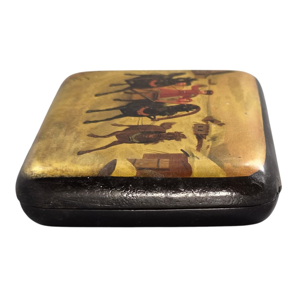 A rectangular 19th-century Russian lacquer cigarette case featuring a hand-painted scene of three horses pulling a sleigh across a snowy landscape on a gold background. View XV