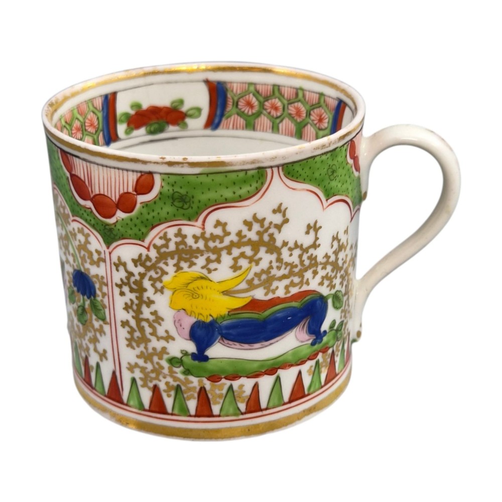 A Regency period Worcester porcelain coffee cup and matching saucer decorated in the hand-painted Dragon in Compartments pattern with green, red, blue, and gilt detailing. View IV