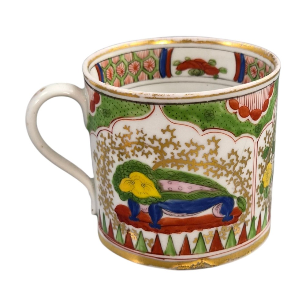A Regency period Worcester porcelain coffee cup and matching saucer decorated in the hand-painted Dragon in Compartments pattern with green, red, blue, and gilt detailing. View VI