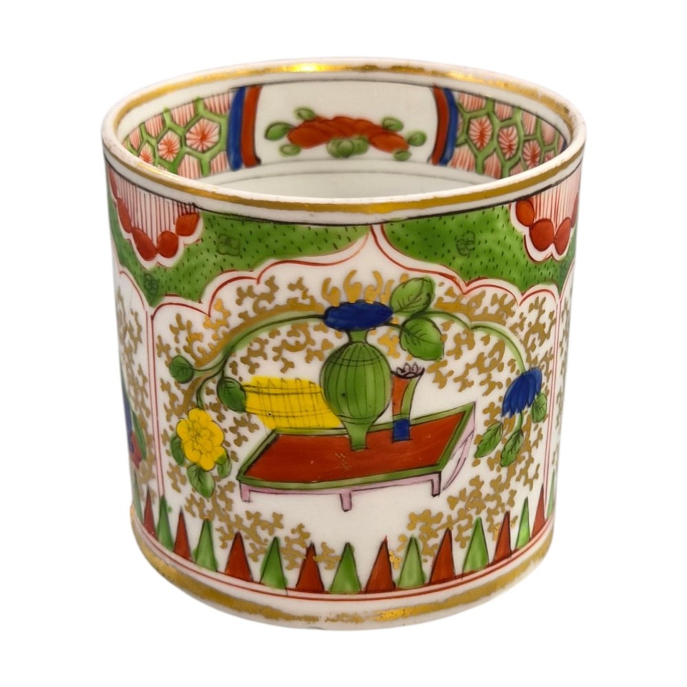 A Regency period Worcester porcelain coffee cup and matching saucer decorated in the hand-painted Dragon in Compartments pattern with green, red, blue, and gilt detailing. View VII
