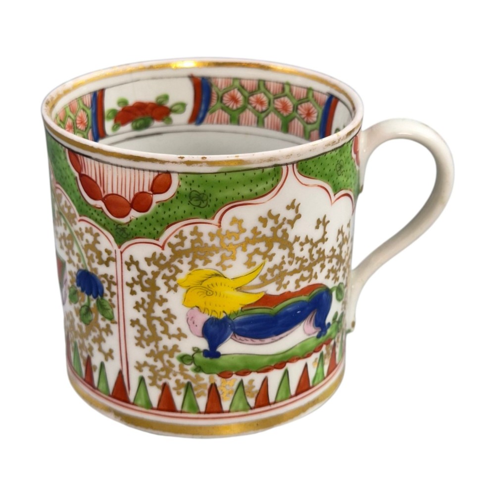 A Regency period Worcester porcelain coffee cup and matching saucer decorated in the hand-painted Dragon in Compartments pattern with green, red, blue, and gilt detailing. View VIII