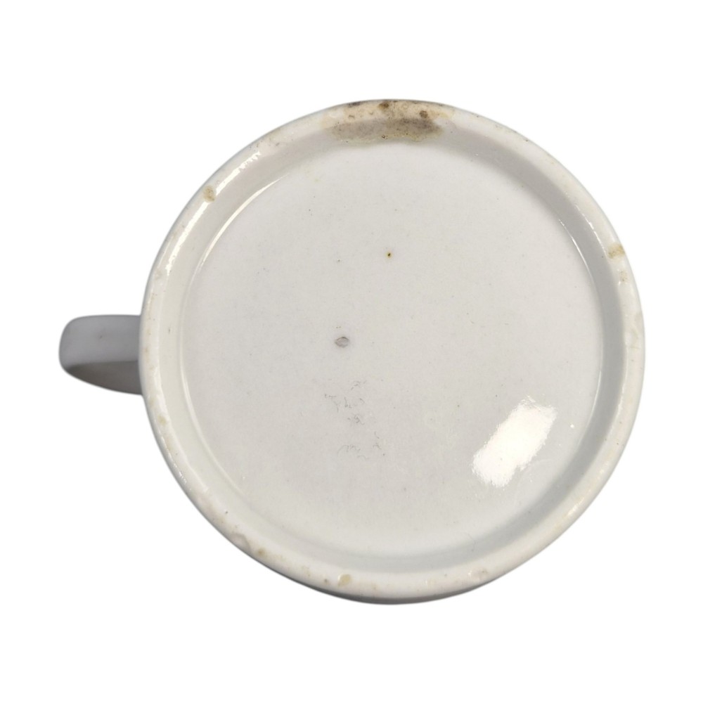 A Regency period Worcester porcelain coffee cup and matching saucer decorated in the hand-painted Dragon in Compartments pattern with green, red, blue, and gilt detailing. View X