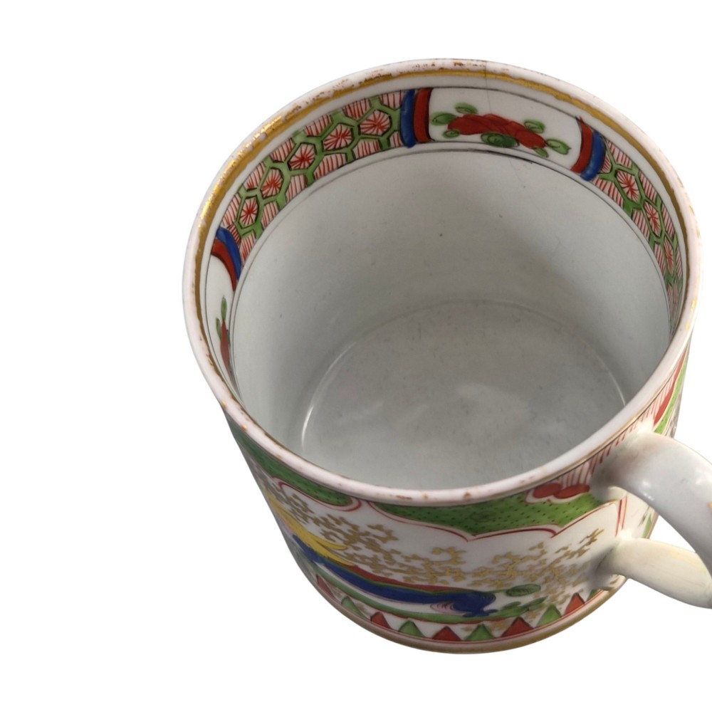 A Regency period Worcester porcelain coffee cup and matching saucer decorated in the hand-painted Dragon in Compartments pattern with green, red, blue, and gilt detailing. View XII