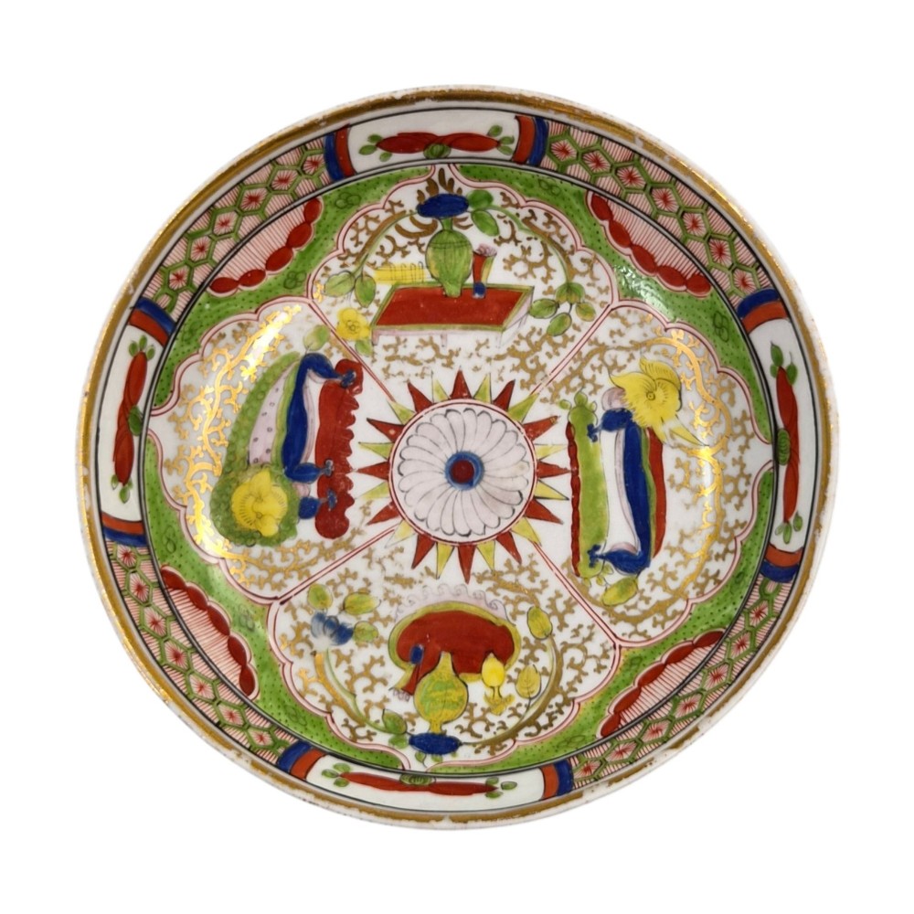 A Regency period Worcester porcelain coffee cup and matching saucer decorated in the hand-painted Dragon in Compartments pattern with green, red, blue, and gilt detailing. View XIV