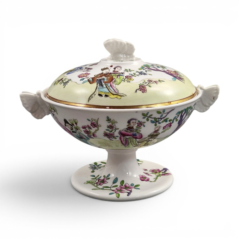 A Regency Spode felspar porcelain covered pedestal bowl with hand-painted chinoiserie figures, floral motifs, sculpted butterfly handles, and gilded rims.