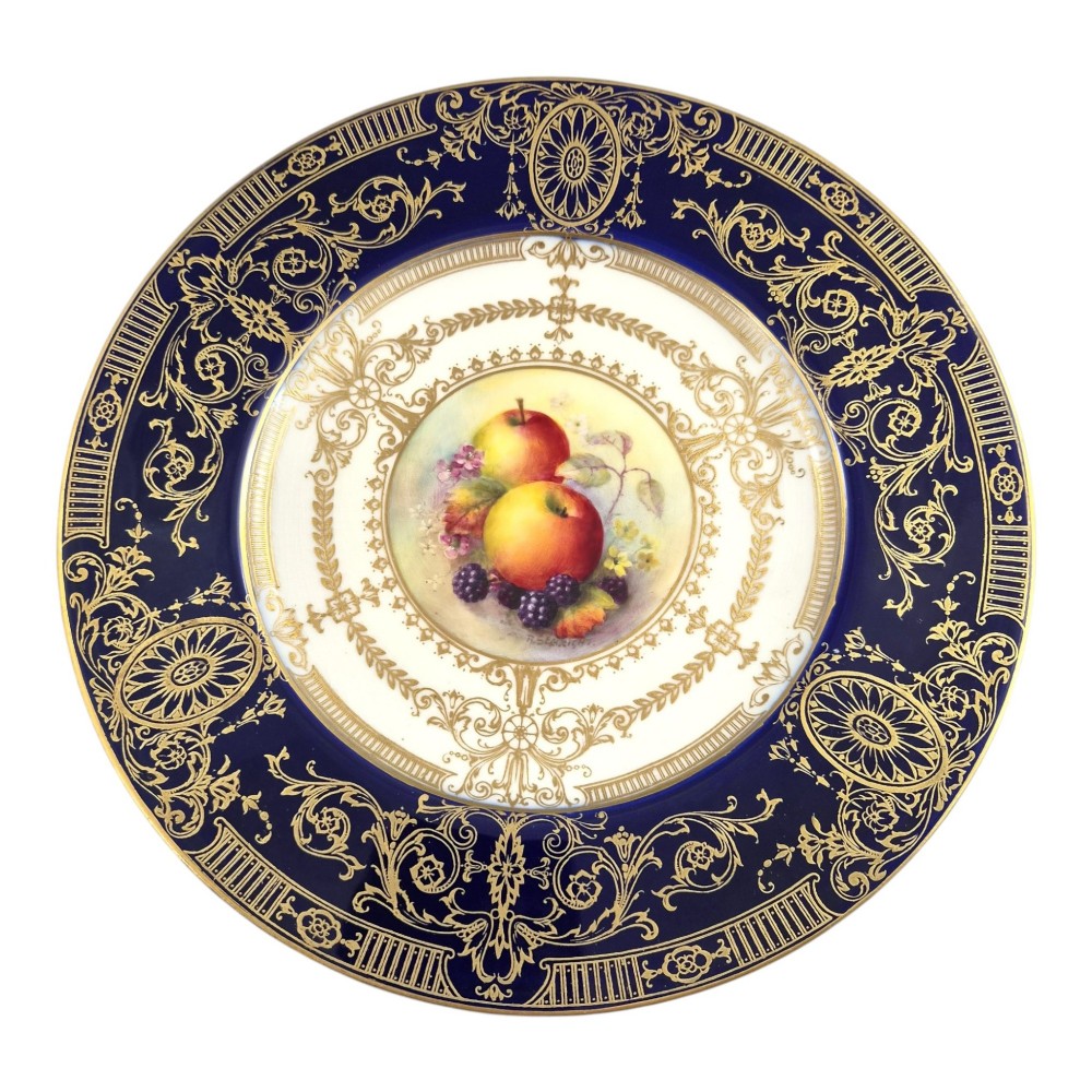 A circular Royal Worcester porcelain cabinet plate featuring a cobalt blue rim with detailed gold gilding framing a central painted still life of apples and berries. View VIII