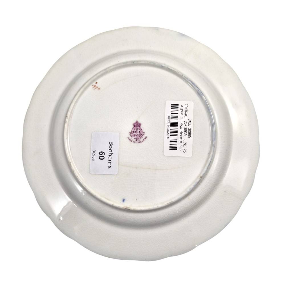 A circular porcelain cabinet plate featuring a central hand-painted fruit still life surrounded by a gilded sunburst pattern and a cobalt blue rim embellished with gold floral scrollwork. View IX