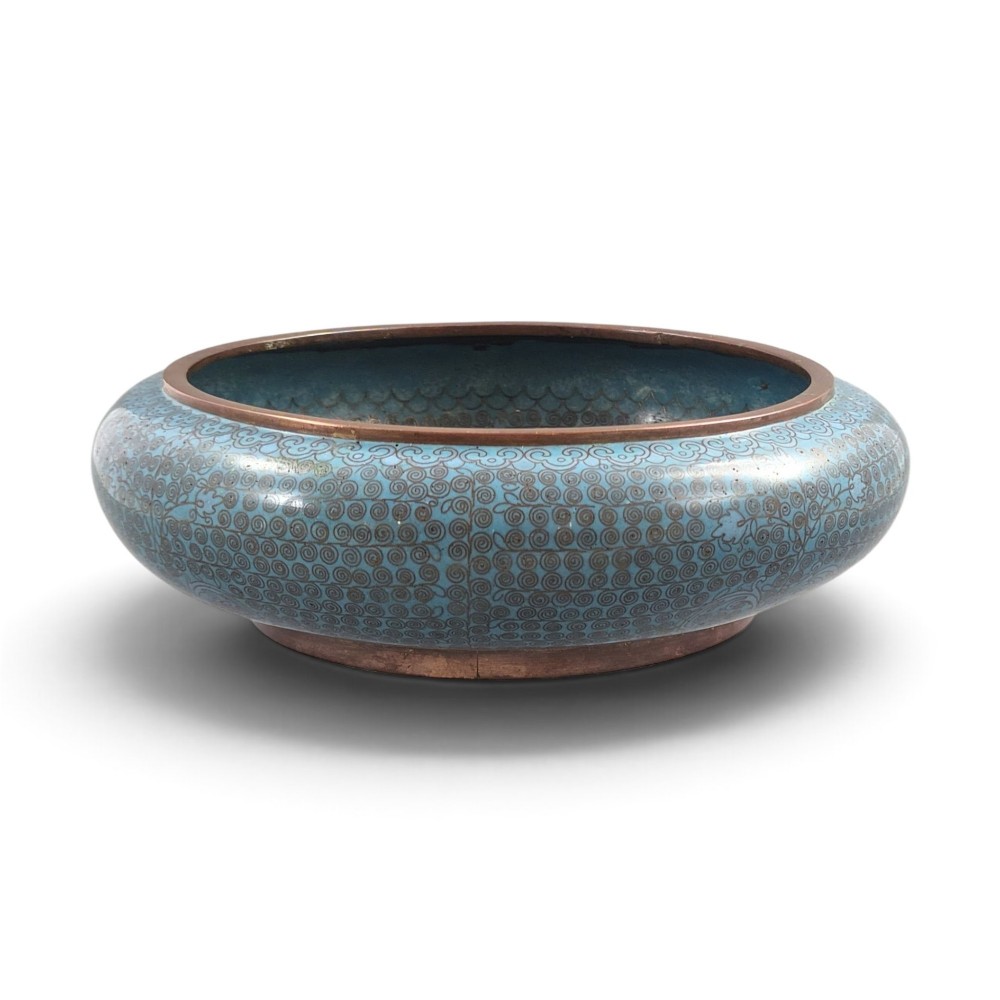 A low, rounded Chinese cloisonne enamel scholars brush washer featuring intricate wire scroll motifs on a turquoise blue ground with exposed metal rims.