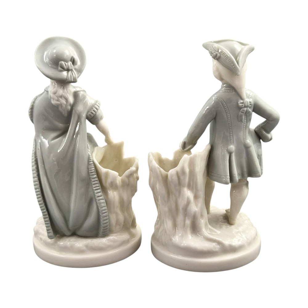 A pair of late Victorian grey and cream glazed porcelain figural salts depicting a man and woman beside hollow tree stump vessels. View III