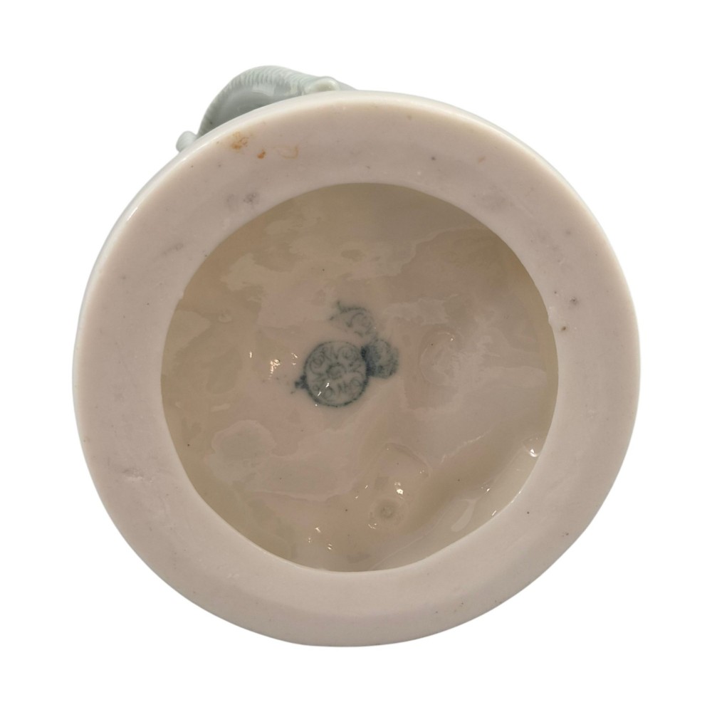 A pair of late Victorian grey and cream glazed porcelain figural salts depicting a man and woman beside hollow tree stump vessels. View VIII
