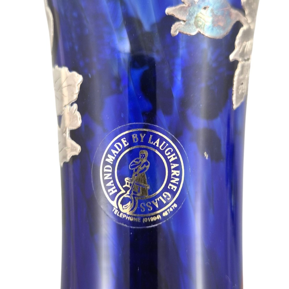 A cobalt blue glass vase and matching perfume bottle with stopper, both featuring intricate sterling silver floral overlay. View VIII