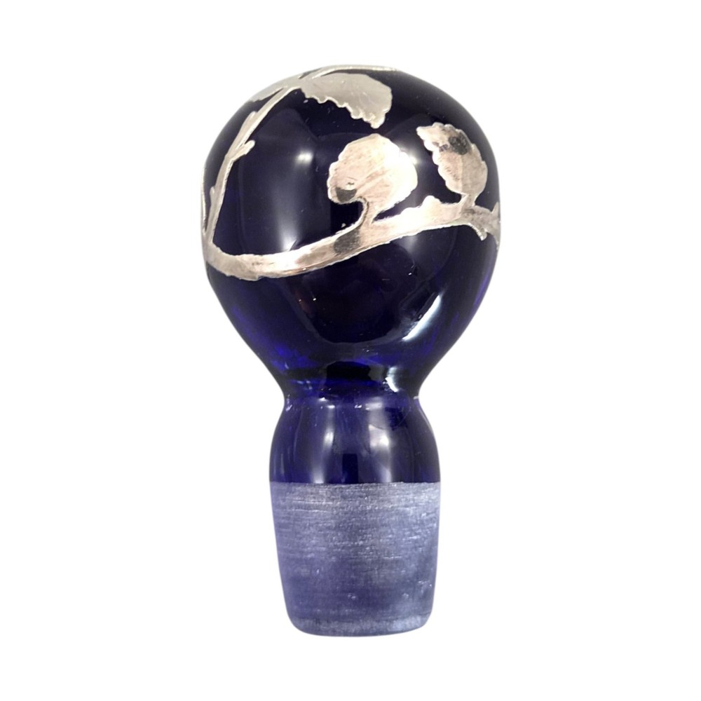 A cobalt blue glass vase and matching perfume bottle with stopper, both featuring intricate sterling silver floral overlay. View XIV