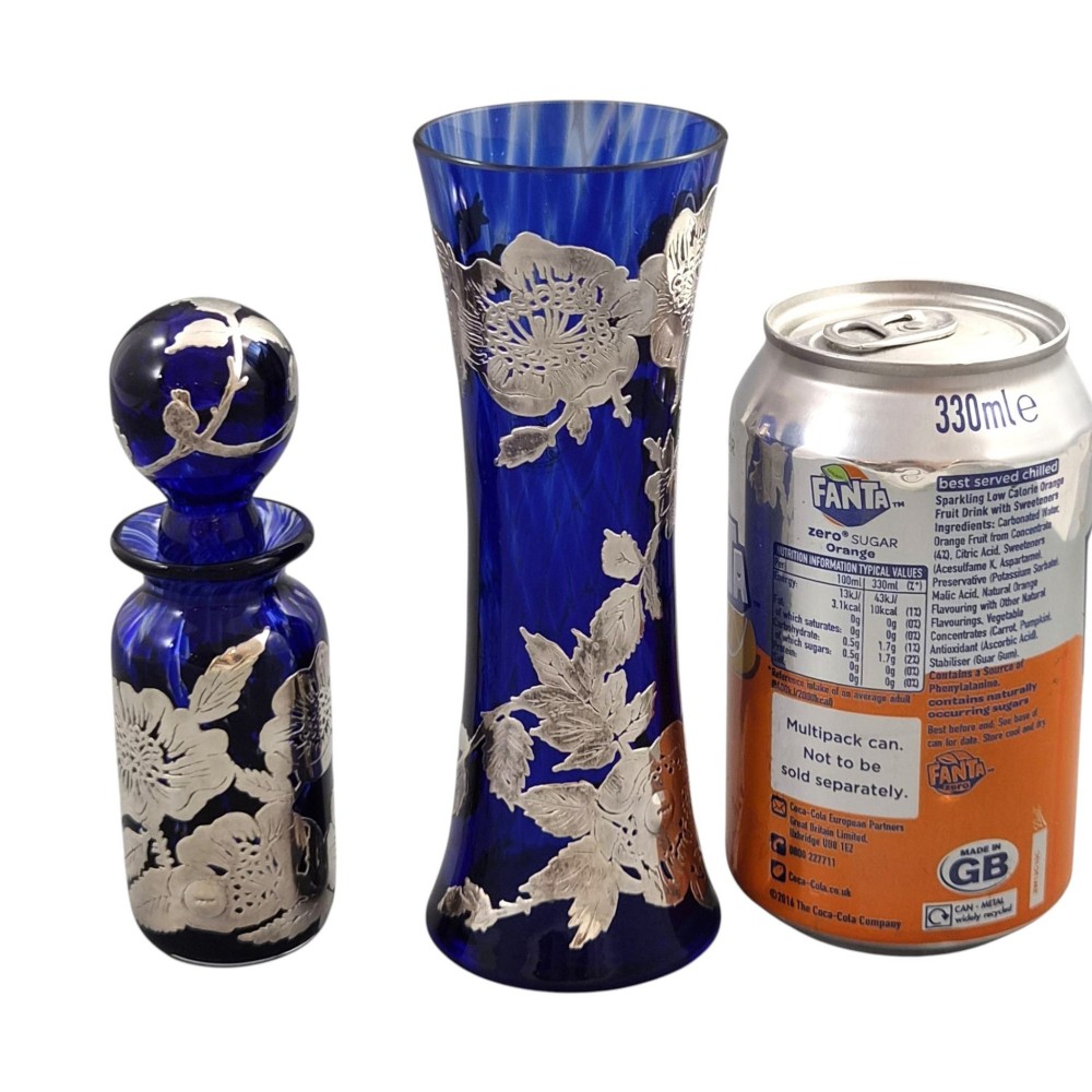 A cobalt blue glass vase and matching perfume bottle with stopper, both featuring intricate sterling silver floral overlay. View XV