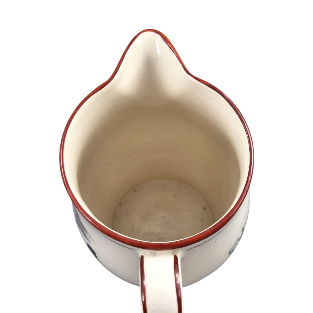 A Georgian creamware jug featuring a black transfer-printed hunting scene and terracotta red painted rim accents against a cream glaze. View VII