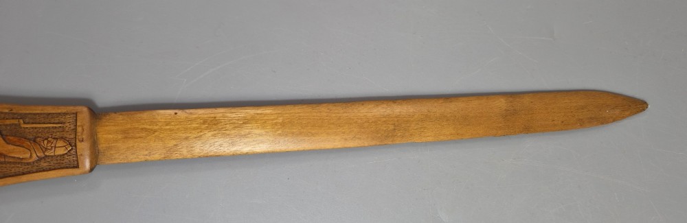 A hand-carved wooden letter opener featuring a relief carving of a soldier on the handle and carved text reading Krasnojarsk Sziberia 1916 on the blade. View IX
