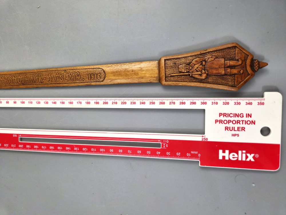 A hand-carved wooden letter opener featuring a relief carving of a soldier on the handle and carved text reading Krasnojarsk Sziberia 1916 on the blade. View XI