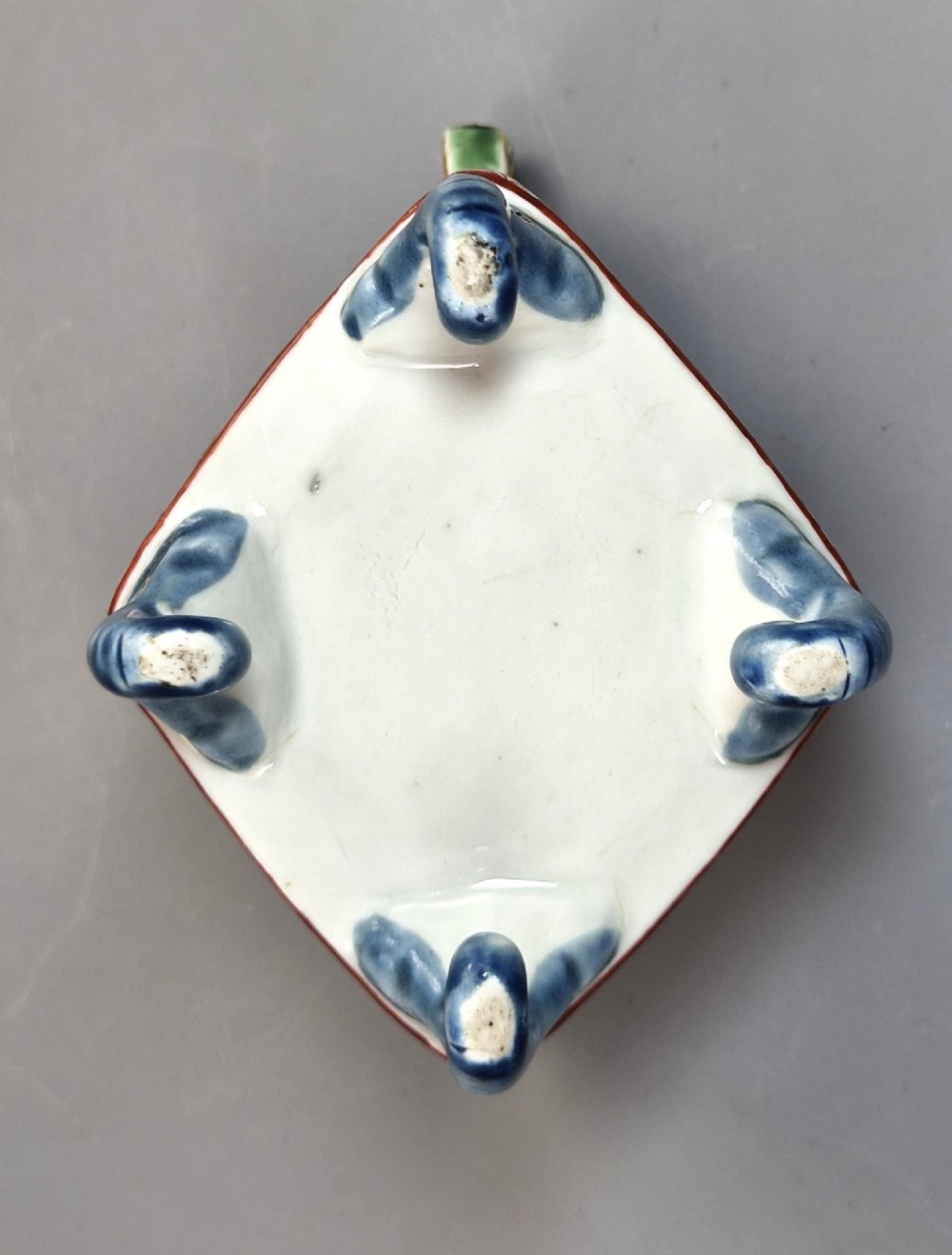 A square Japanese Kutani porcelain incense burner featuring a karashishi lion finial on the lid, hand-painted figural panels, and blue elephant-head legs. View VI