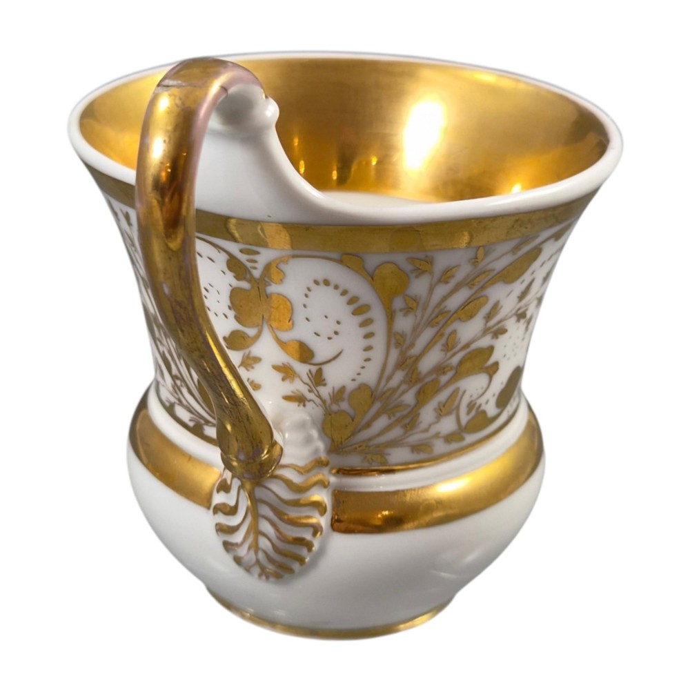 A 19th-century KPM Berlin porcelain cabinet cup with a fully gilded interior, high curved loop handle, and hand-painted topographical view of Peacock Island. View VIII