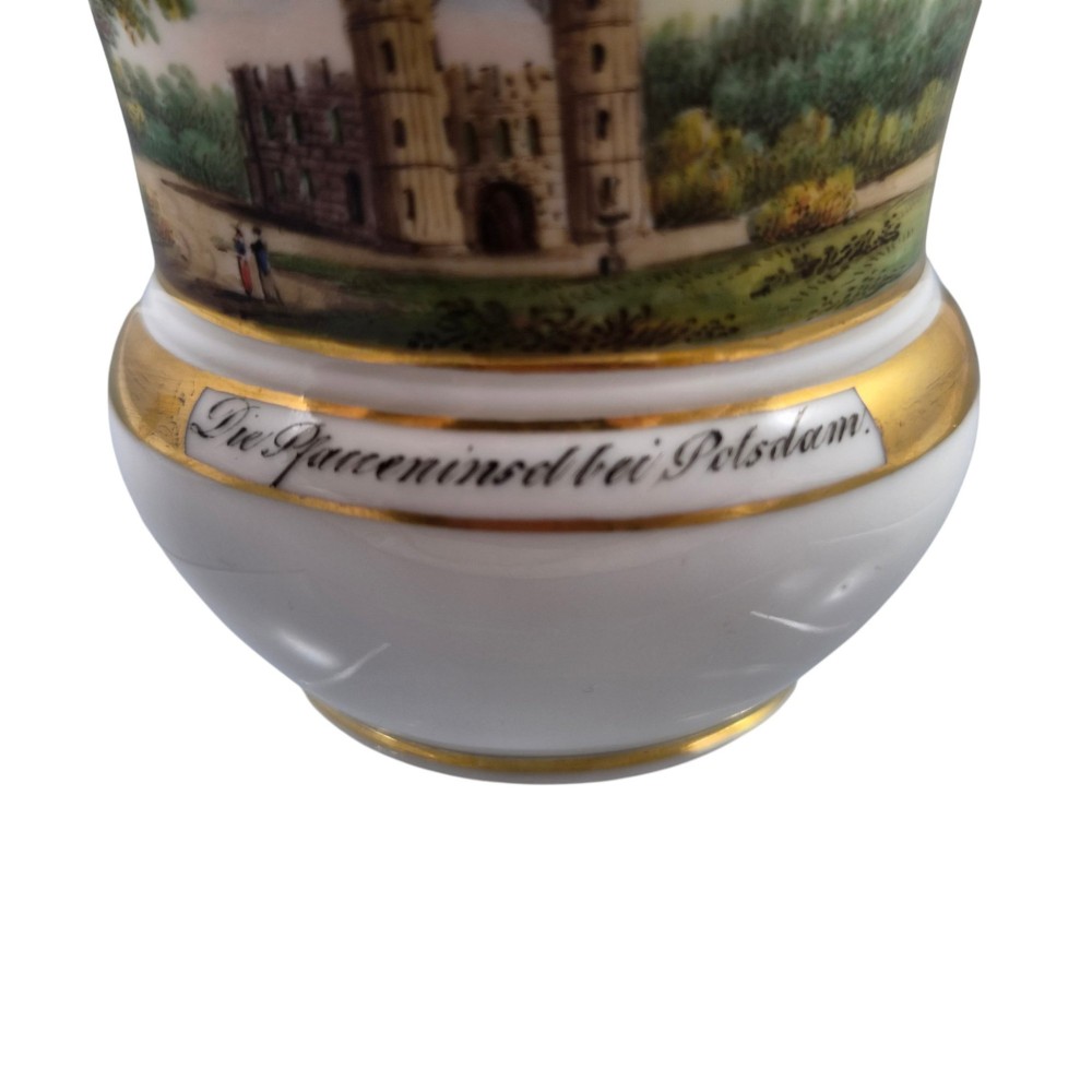 A 19th-century KPM Berlin porcelain cabinet cup with a fully gilded interior, high curved loop handle, and hand-painted topographical view of Peacock Island. View XI