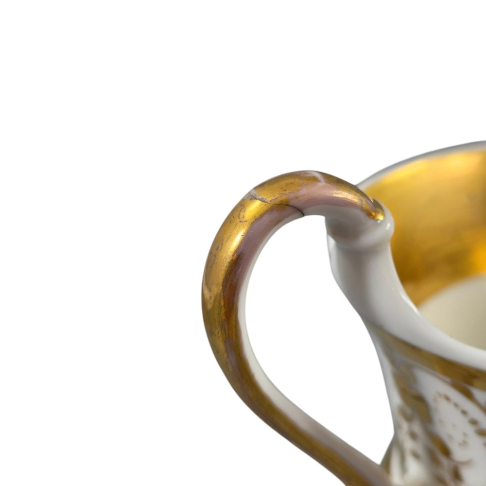 A 19th-century KPM Berlin porcelain cabinet cup with a fully gilded interior, high curved loop handle, and hand-painted topographical view of Peacock Island. View XIV