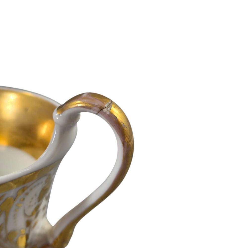 A 19th-century KPM Berlin porcelain cabinet cup with a fully gilded interior, high curved loop handle, and hand-painted topographical view of Peacock Island. View XV