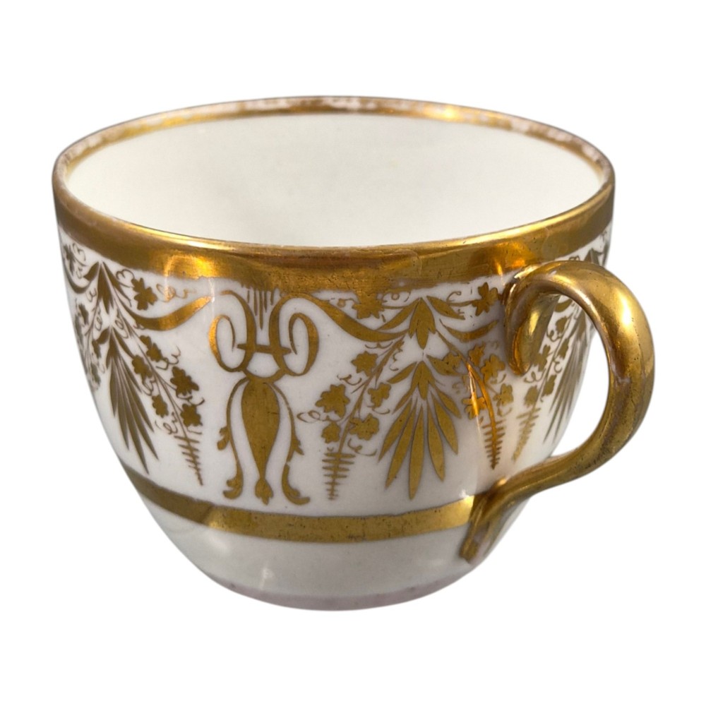An early nineteenth-century KPM Berlin porcelain cabinet cup and saucer decorated with gilt foliage patterns and hand-painted landscape scenes. View XIII