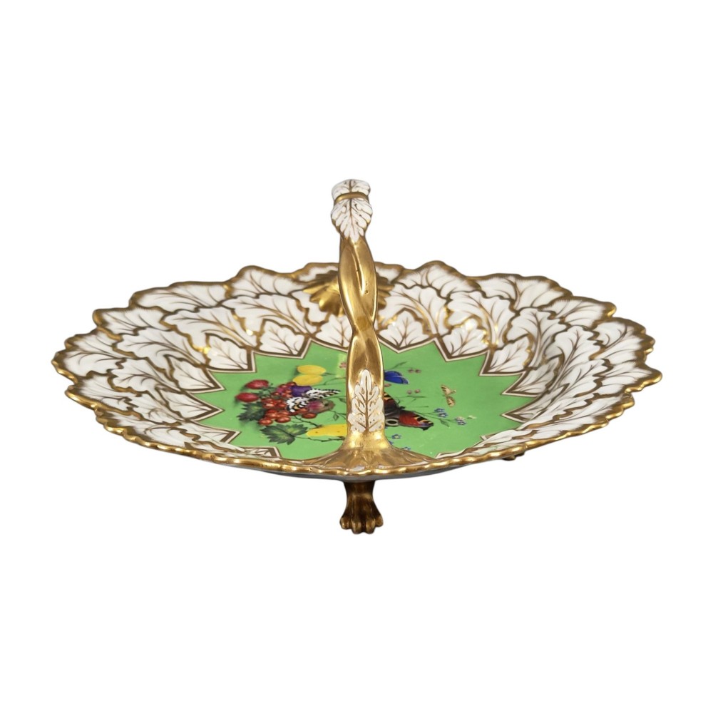 A Regency Flight, Barr and Barr Worcester porcelain handle basket featuring a bright green central reserve decorated with hand-painted butterflies and berries, surrounded by a leaf-moulded rim and gilt handle. View III