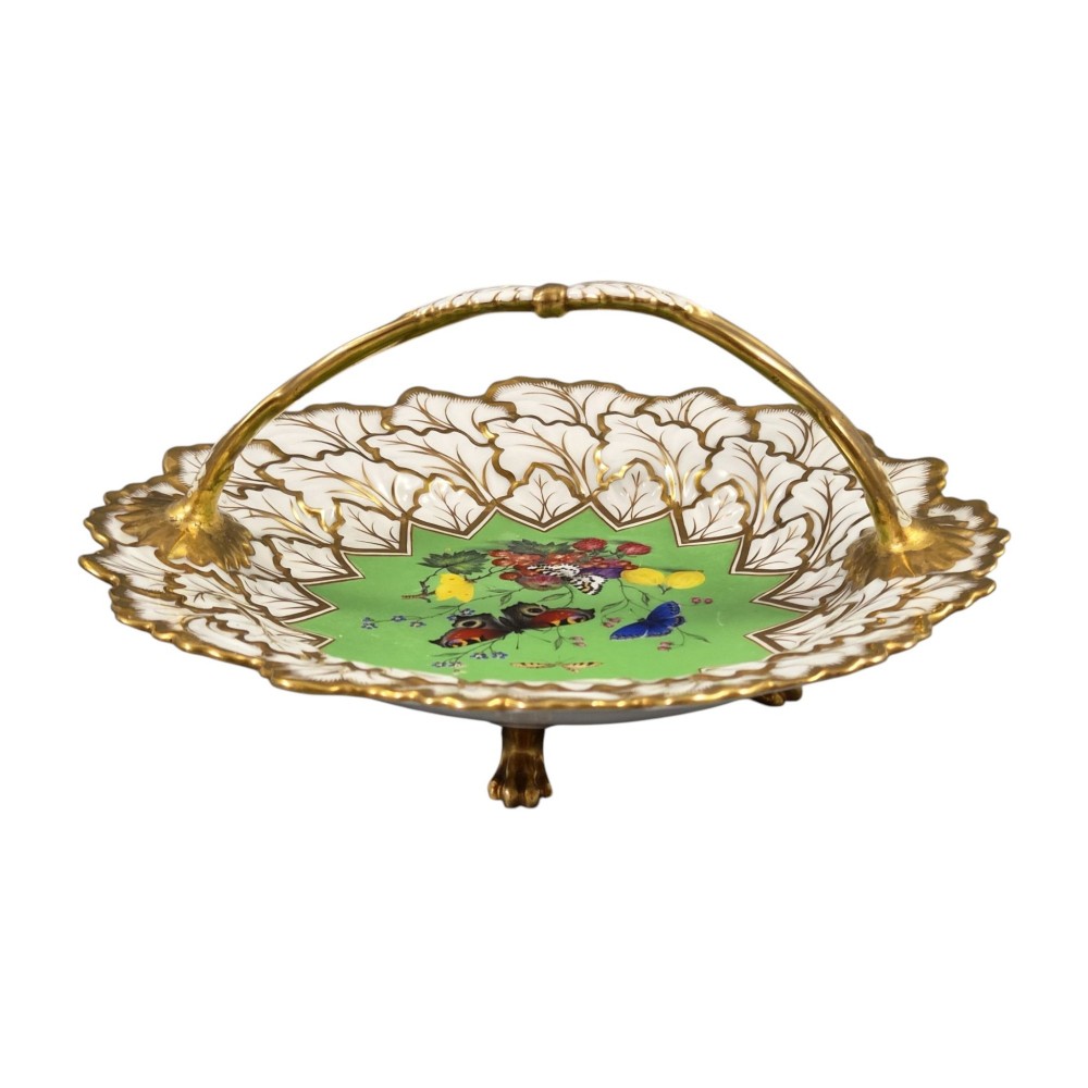 A Regency Flight, Barr and Barr Worcester porcelain handle basket featuring a bright green central reserve decorated with hand-painted butterflies and berries, surrounded by a leaf-moulded rim and gilt handle. View IV