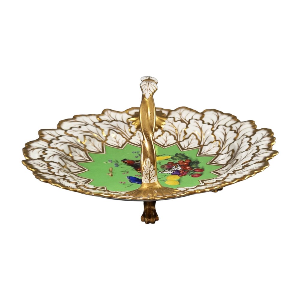 A Regency Flight, Barr and Barr Worcester porcelain handle basket featuring a bright green central reserve decorated with hand-painted butterflies and berries, surrounded by a leaf-moulded rim and gilt handle. View V