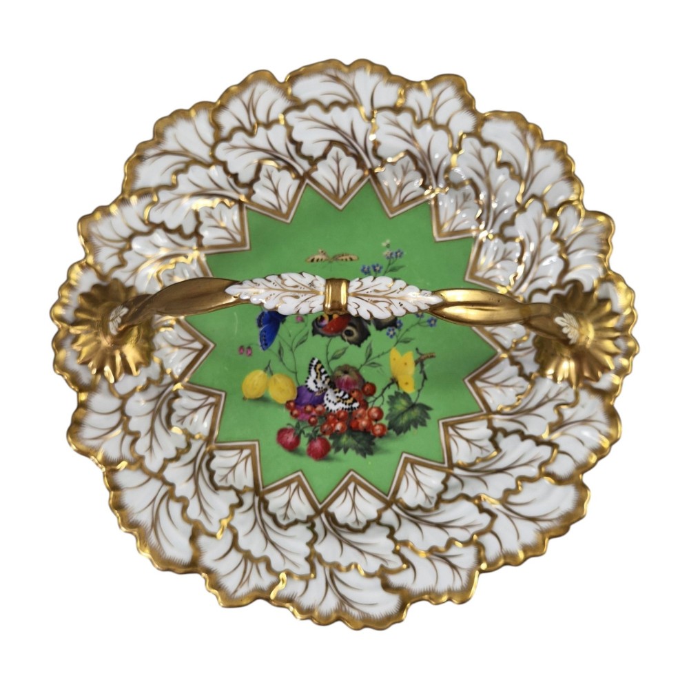 A Regency Flight, Barr and Barr Worcester porcelain handle basket featuring a bright green central reserve decorated with hand-painted butterflies and berries, surrounded by a leaf-moulded rim and gilt handle. View VII