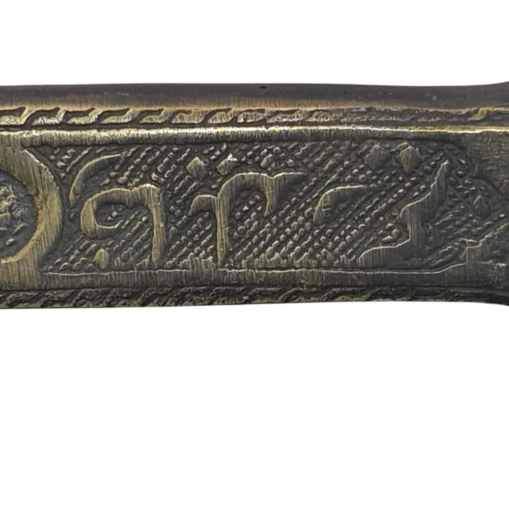 An antique cast and engraved brass travelling pen case and integrated inkwell featuring ornate scrollwork patterns and script. View V