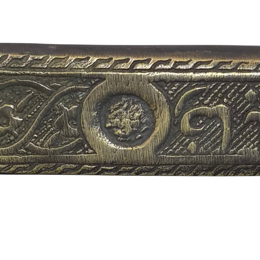 An antique cast and engraved brass travelling pen case and integrated inkwell featuring ornate scrollwork patterns and script. View VI